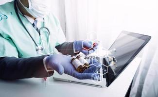 Medicine doctor hand working on a patients x-ray scans digital healthcare and connection with modern virtual screen interface icons, Medical technology and network concept. photo
