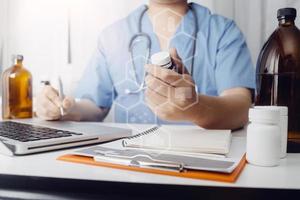 Medicine doctor hand working on a patients x-ray scans digital healthcare and connection with modern virtual screen interface icons, Medical technology and network concept. photo