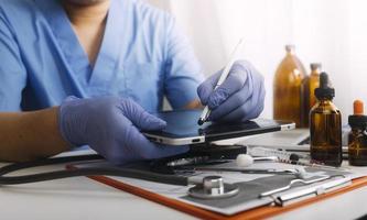 Medicine doctor hand working on a patients x-ray scans digital healthcare and connection with modern virtual screen interface icons, Medical technology and network concept. photo