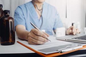Medicine doctor hand working on a patients x-ray scans digital healthcare and connection with modern virtual screen interface icons, Medical technology and network concept. photo