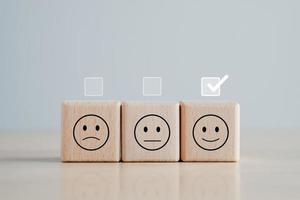 Feedback rating and positive customer service review. Mental health assessment, World mental health day, think positive and satisfaction survey concept. Select happy from normal and Sad emotion. photo