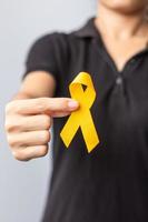 Suicide prevention day, Childhood, Sarcoma, bone and bladder cancer Awareness month, Yellow Ribbon for supporting people life and illness. children Healthcare and World cancer day concept photo