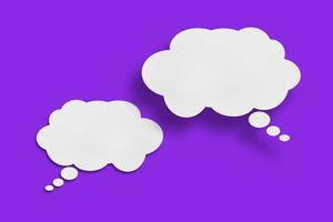 white cloud paper speech bubble shape against purple background photo