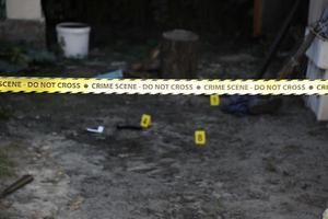 Crime scene tape for covering the area cordon. Yellow tape with blurred forensic law enforcement background in cinematic tone photo