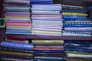 Patterned Textile Fabrics  stacked on a retail Shop Shelf for sale photo