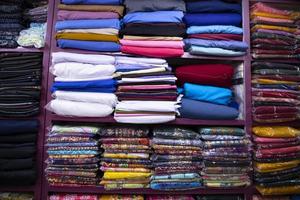 Patterned Textile Fabrics  stacked on a retail Shop Shelf for sale photo