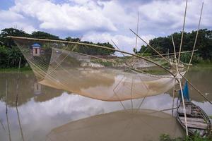 Traditional Fishing net Vessel  in the river water by Bangladesh photo