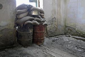 Sandbags piled up at a window of a house in the buffer zone Green Line in Nicosia, Cyprus photo