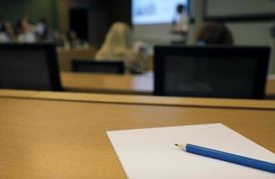 During a lecture or presentation - pen and paper in an auditorium photo