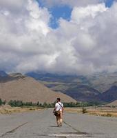 Man seen from the back as he walks on an abandoned airfield photo