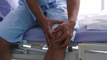 An elderly Asian male patient is hospitalized with knee pain. photo