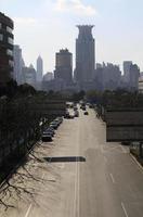 Quiet road and rows of skyscrapers in the city of Shanghai, China photo