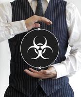 Man holding a sign with bio hazard symbol photo