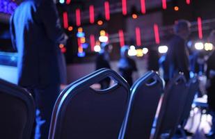 Empty chairs in the first row at conference before the event photo