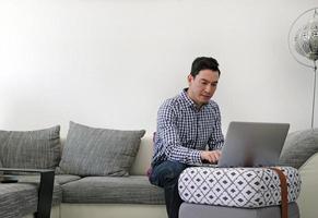 Man working from home with a laptop in the living room photo