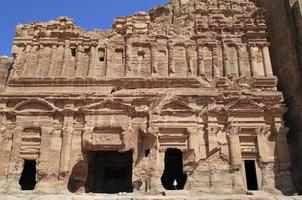 Size comparison - A man in an ancient building in Petra, Jordan photo