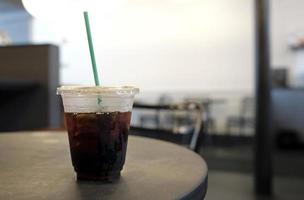 Selective focus on a cold brew coffee with the brightly lit cafe in the background photo