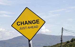 Yellow road sign with the words CHANGE - JUST AHEAD on it photo