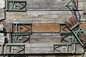 A wall filled with wooden benches photo