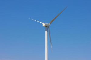 Wind farm, Wind farms. Wind power is the use of air flow through wind turbines to mechanically Power generators for electric power. photo