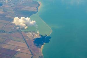 Aerial photo of Farmland. view from the plane to the ground. squares of fields under the clouds