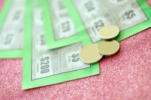 Close up view of green lottery scratch cards. Many used fake instant lottery tickets with gambling results. Gambling addiction photo