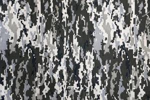 Fabric with texture of Ukrainian military pixeled camouflage. Cloth with camo pattern in grey, brown and green pixel shapes. Official uniform of Ukrainian soldiers photo