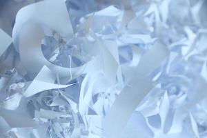 Shredded paper texture background, top view of many white paper strips. Pile of cut paper like box filler for shipping fragile items photo