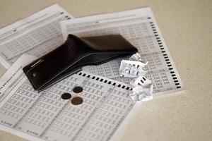 Crumpled lottery tickets and empty purse as symbol of losing the lottery game. Unlucky gambling results. Misfortune photo