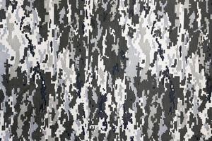 Fabric with texture of Ukrainian military pixeled camouflage. Cloth with camo pattern in grey, brown and green pixel shapes. Official uniform of Ukrainian soldiers photo