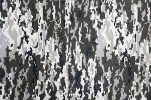 Fabric with texture of Ukrainian military pixeled camouflage. Cloth with camo pattern in grey, brown and green pixel shapes. Official uniform of Ukrainian soldiers photo