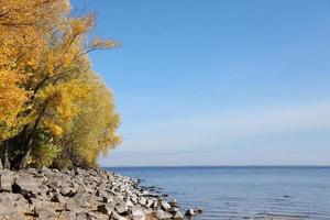 Beautiful autumn landscape with lake and multicoloral trees. Picturesque place with lake and tall trees photo