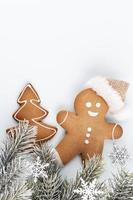 Gingerbread man, cookies and Christmas decor on pastel background. photo