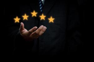 Business man hand customer or client holding the stars to complete five stars with copy space.business satisfaction feedback marketing concept. photo