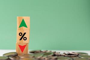 Business finance and banking investments economy stack coin inflation and arrow red and green with wood cube on desk. photo