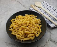 Raw Italian Fusilli Pasta. Traditional Italian cuisine. photo