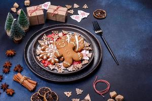 Christmas decorations and gingerbreads on a dark concrete table. Preparing and decorating the house for holiday photo