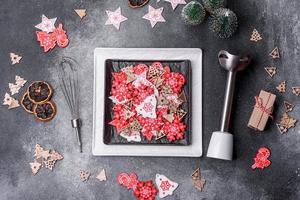 Christmas decorations and gingerbreads on a dark concrete table. Getting ready to celebration photo