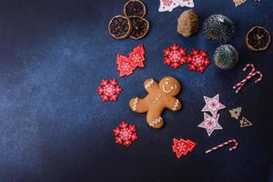 Christmas decorations and gingerbreads on a dark concrete table photo