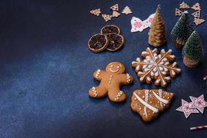 Christmas decorations and gingerbreads on a dark concrete table photo