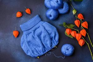 Children's blouse tied with their own hands from blue woolen threads photo