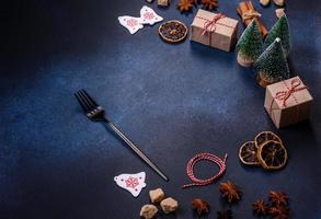 Christmas decorations and gingerbreads on a dark concrete table. Preparing and decorating the house for holiday photo