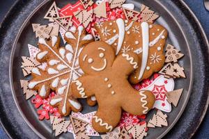 Christmas decorations and gingerbreads on a dark concrete table. Preparing and decorating the house for holiday photo
