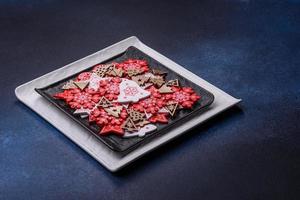 Christmas decorations and gingerbreads on a dark concrete table. Getting ready to celebration photo