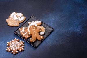 Christmas decorations and gingerbreads on a dark concrete table. Getting ready to celebration photo
