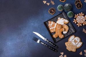 Christmas decorations and gingerbreads on a dark concrete table. Getting ready to celebration photo