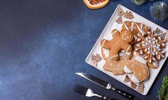 Christmas decorations and gingerbreads on a dark concrete table. Getting ready to celebration photo
