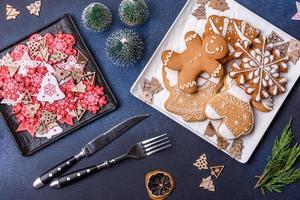 Christmas decorations and gingerbreads on a dark concrete table. Getting ready to celebration photo
