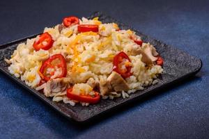 Homemade chinese fried rice with vegetables and a chicken photo