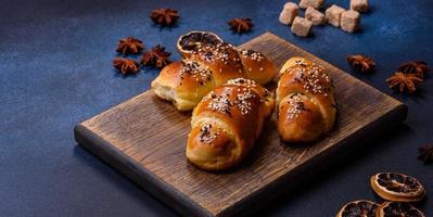 Delicious homemade pastries with apricot jam sprinkled with sesame seeds photo